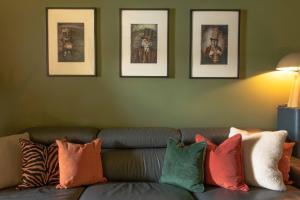 a living room with a couch with colorful pillows at Suite60Solace in Plymouth