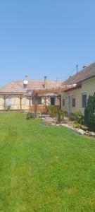 a house with a yard with green grass at Kovács apartman in Balatonberény