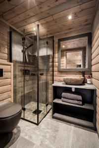 a bathroom with a shower and a toilet and a mirror at Skyline Lodge in Stryn