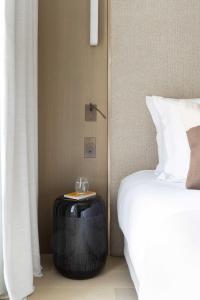 a bedroom with a bed and a table next to a bed at Rive 15 - Appartements Parisiens in Paris +288 photos