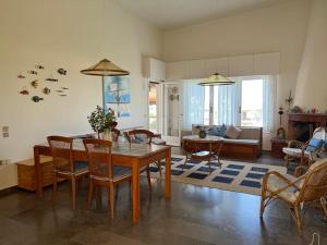 a living room with a wooden table and chairs at Villa Cathrine in Kanali