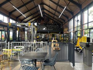 a workshop with a table and chairs and a room with machinery at Greenlee Lifestyle Apartment- 2 Bedroom in Sandton