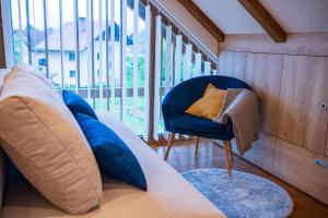a living room with a couch and a chair at Cozy House Claudia in Žirovnica