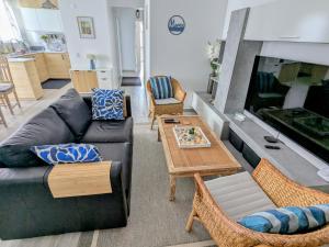 a living room with a couch and a fireplace at Tavira Garden Oasis in Tavira