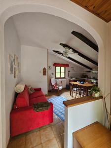 a living room with a red couch and a table at La casa di Marta in Campo Tizzoro