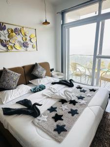 a bed with stars on it in a room at Advaya Stays Luxury 1BHK Villa- The Sunrise Studio in Mukteswar +11 photos