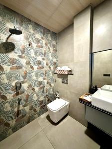 a bathroom with a toilet and a sink at Advaya Stays Luxury 1BHK Villa- The Sunrise Studio in Mukteswar