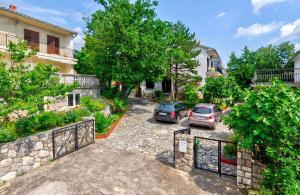 a couple of cars parked in a parking lot at Apartment in Jadranovo 39395 in Jadranovo +13 photos