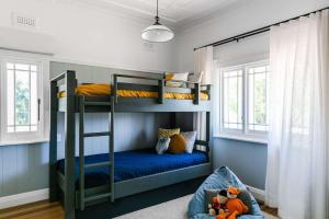 a bunk bed room with two bunk beds and a couch at Hide and Seek Estate, Kangaroo Valley in Upper Kangaroo River +31 photos
