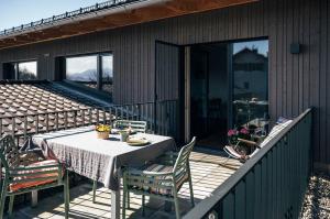 a table on the deck of a house at Ferienwohnung Heberle in Traunstein
