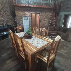 a dining room table with chairs and a couch at Kudu Mal in Marloth Park