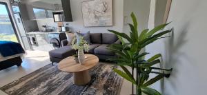 a living room with a couch and a table at Ocean Club Zimbali Lakes D16 in Ballito