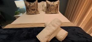 a bed with a cross on top of it at Ocean Club Zimbali Lakes D16 in Ballito +18 photos