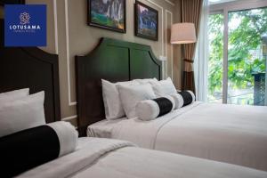 Voodi või voodid majutusasutuse Lotusama Central Hanoi Hotel toas