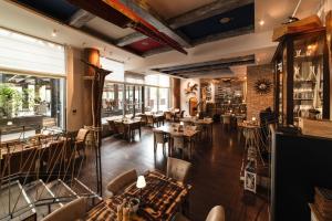 a restaurant with tables and chairs in a room at Eurovea Tower Apartments free Parking in Bratislava