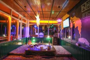 a room with a table in the middle of a building at Pahadirovers Homestay & Cafe in Kasol