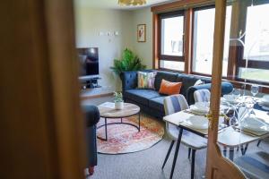 a living room with a couch and a table at Rosehearty house - 3 bedroom in Rosehearty