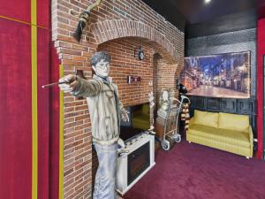 a statue of a boy standing in a brick room at Harry-Potter in Troyes