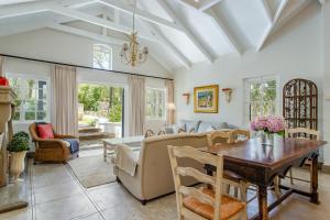 a living room with a couch and a table at Franschhoek Rose Cottages in Franschhoek