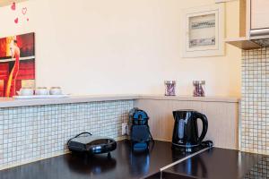 a kitchen with a coffee maker on a counter at Modern Studios in the Heart of Filiatra with Private Balconies in Filiatra