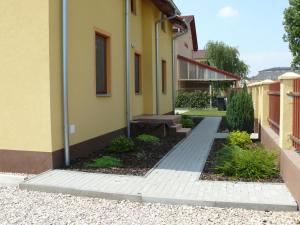 a courtyard of a building with a bench next to it at Aquasleep in Veľký Meder