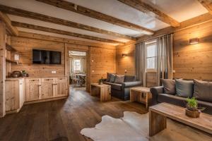 a living room with two chairs and a television at Mountain Chalet Pia in La Valle