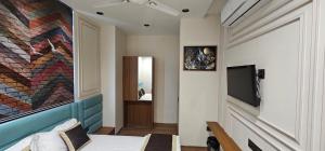 a room with a bed and a painting on the wall at Hotel Nexus Inn in Ahmedabad