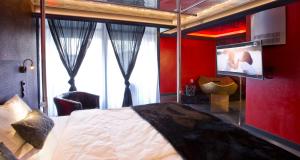 a bedroom with a large bed and a tv in it at PLAZA INN stays design Dortmund in Dortmund +120 photos