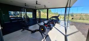 a gym with a scooter in a room with windows at Ocean Club Zimbali Lakes D16 in Ballito