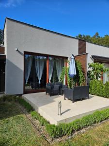 a house with a patio with an umbrella at Apartamenty Wisełka in Wisełka