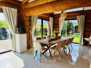 a dining room with a wooden table and chairs at Chalet Matthe Lomnica in Veľká Lomnica