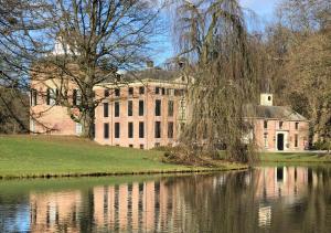 a large brick building next to a body of water at Appartement Klein Waldeck in Velp