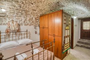 a bedroom with a bunk bed and a stone wall at Medieval Villa Philoxenia in Kalamoti