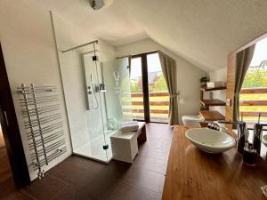 a bathroom with a shower and a toilet and a sink at Chalet Matthe Lomnica in Veľká Lomnica +55 photos