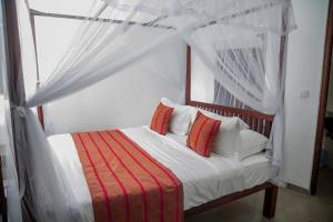 Postel nebo postele na pokoji v ubytování Ramfort Galle