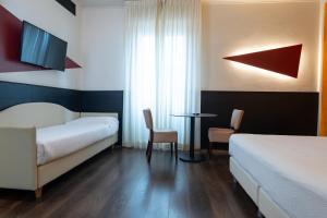 Postel nebo postele na pokoji v ubytování Hotel Italia
