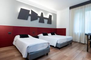 Postel nebo postele na pokoji v ubytování Hotel Italia
