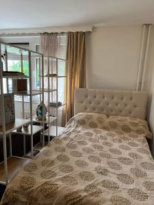 a bedroom with a large bed and a window at Apartment Plan A in Sarajevo