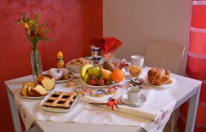 a table topped with plates of bread and fruit at Villa Elena in Montesilvano