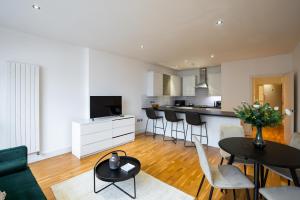 a kitchen and living room with a table and chairs at VESTO Hammersmith in London +46 photos