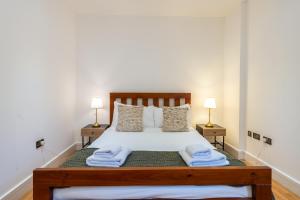 a bedroom with a bed with towels on it at VESTO Hammersmith in London