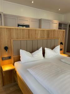 a bedroom with a large bed with white pillows at Gartenvilla in Marktheidenfeld