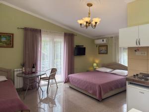a bedroom with a bed and a table in it at VILA TARA in Sutomore