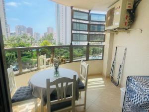 a dining room with a table and a large window at Cozy apartment in Benidorm in Villajoyosa