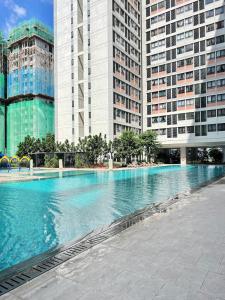 a large swimming pool in front of tall buildings at The Ruby R HorizonSuites KLIA WIFI in Kampung Dengkil +13 photos