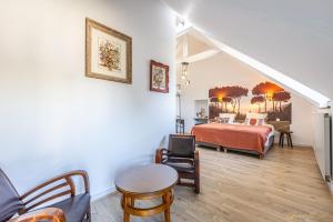 a bedroom with a bed and a table and chairs at Manoir De Rigourdaine in Plouër-sur-Rance +75 photos