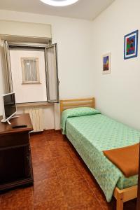 A bed or beds in a room at Casa Stazione Magliana