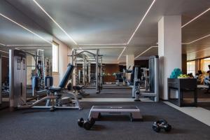 a gym with treadmills and machines in a building at Victoria Golf Resort and Spa Managed by Accor in Vilamoura