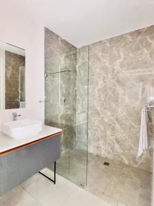 Un baño con lavabo y ducha de cristal. en The Paramount Staycation, en Johannesburgo