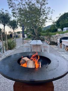 a fire pit in the middle of a patio at New Unique Stone Villa with Seaview, Pool and Garden in Poljane
